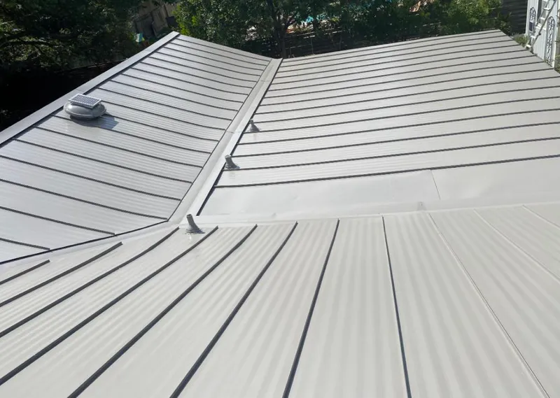 Solar attic fan installed on a metal roof for Roof Ventilation in Rothschild